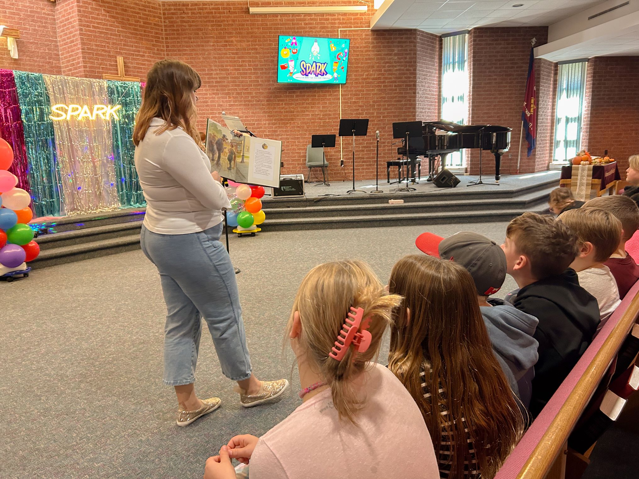 spark story time becca reading a story to children